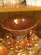 Carnival glass punch bowl and six matching cups, marigold in color antigue
