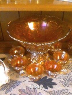 Carnival glass punch bowl and six matching cups, marigold in color antigue